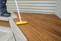 Applying a stain to a deck
