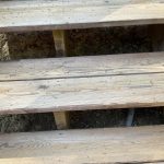 Wooden deck stairs showing weathered and worn planks, relevant to deck restoration and maintenance discussions.
